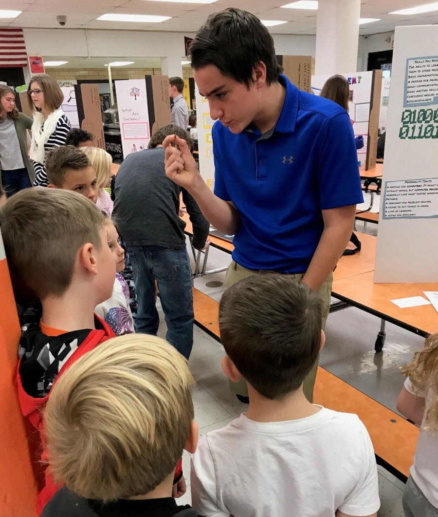 boy talking to young students